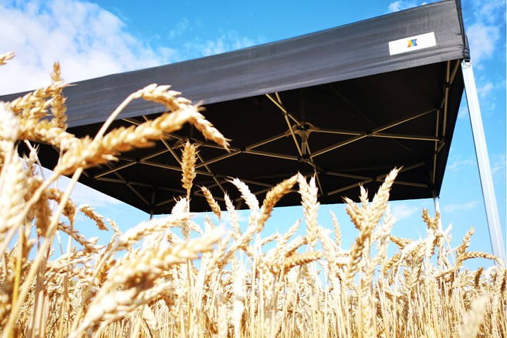 Detail čiernej strešnej plachty stanu 3x6m v pšeničnom poli